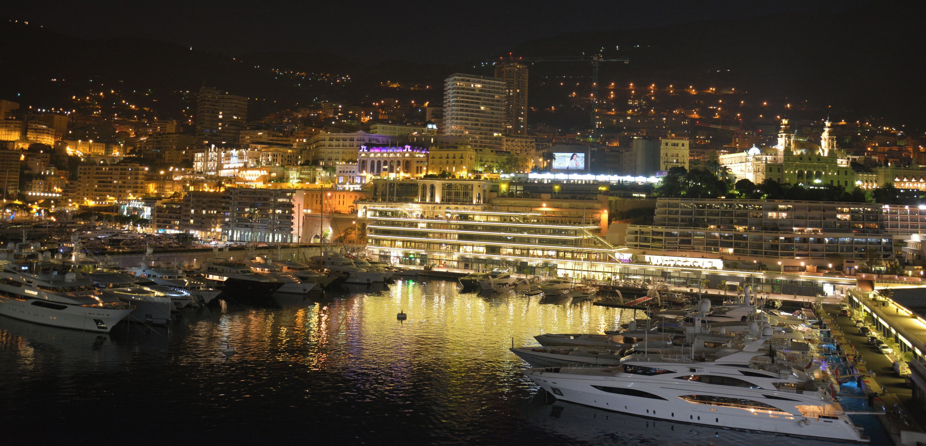 Night harbour with the casino on the hill