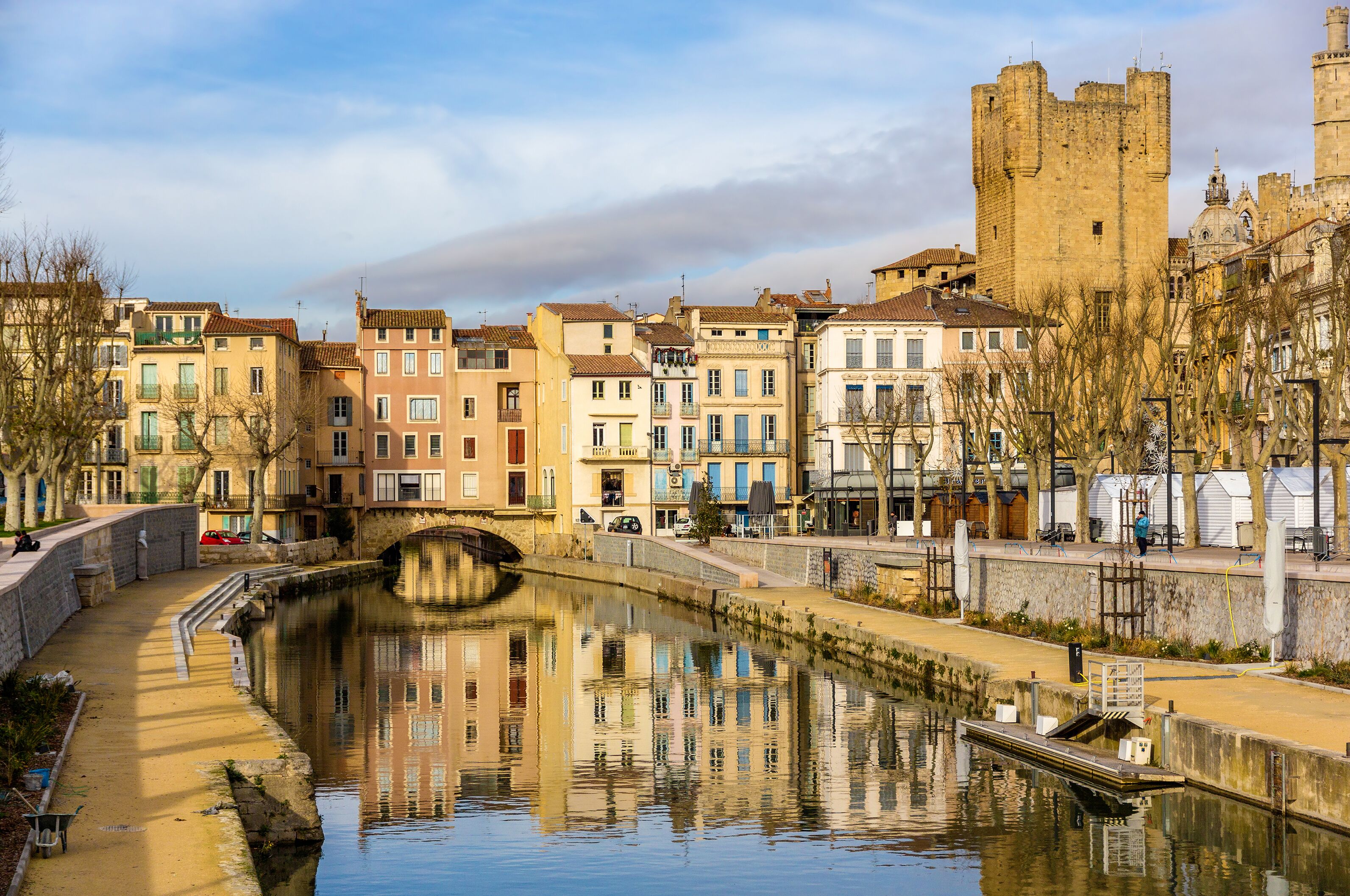 A canal with buildings and a castle.