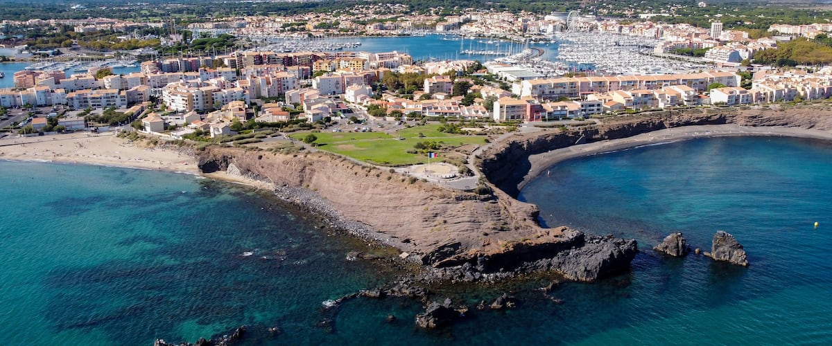 Aerial view of the Cap d'Agde sea resort on the South of France along the Mediterranean Sea - Rocky cape from above