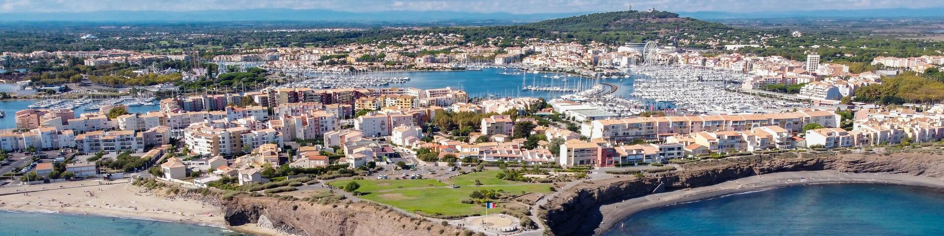 Aerial view of the Cap d'Agde sea resort on the South of France along the Mediterranean Sea - Rocky cape from above