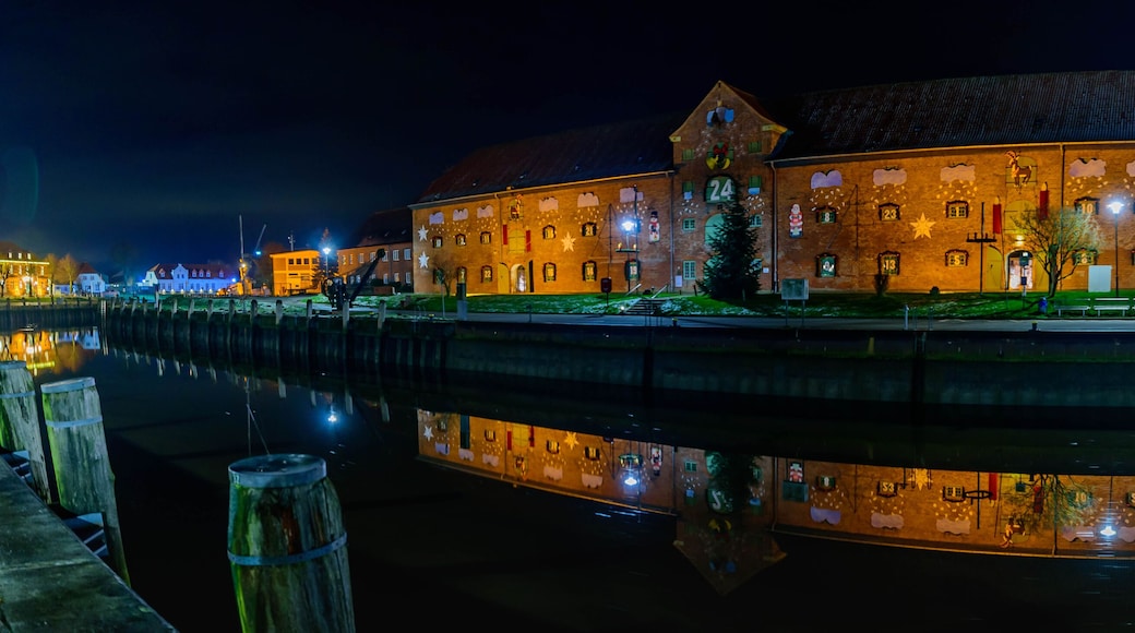 Panorama with view of the harbor with the famous Christmas market on two floors in the historic warehouse on the port of Toenning, Schleswig-Holstein, Germany.
