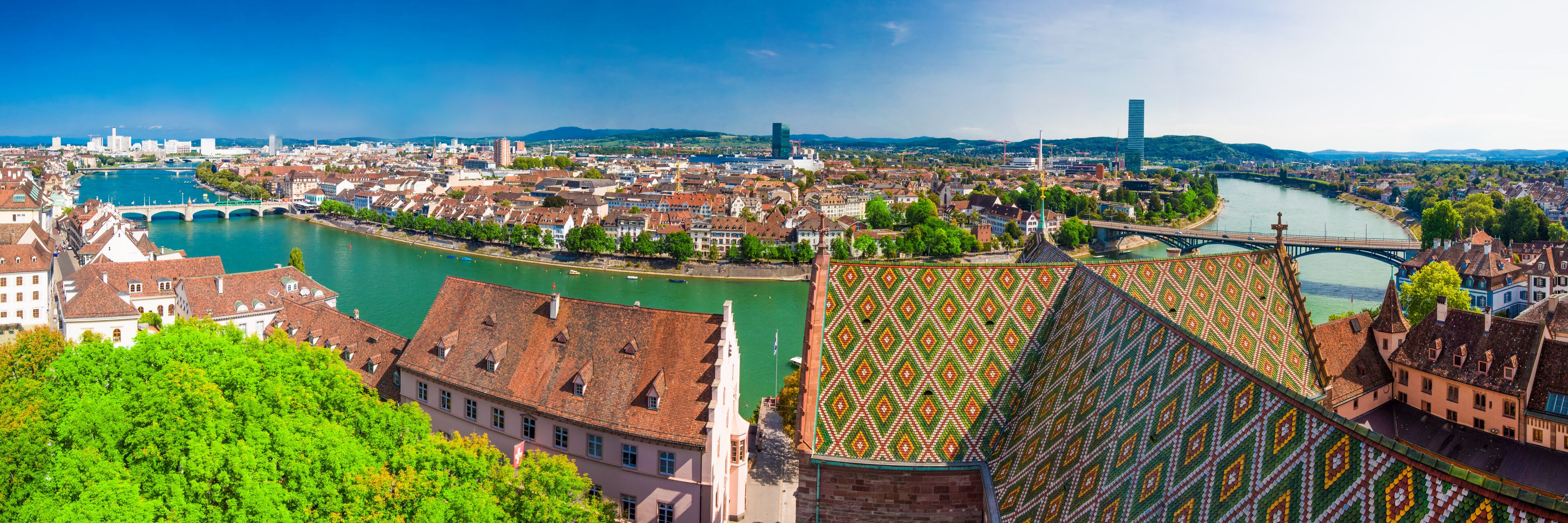 A panoramic view of a city with a river, bridges, and historic buildings.