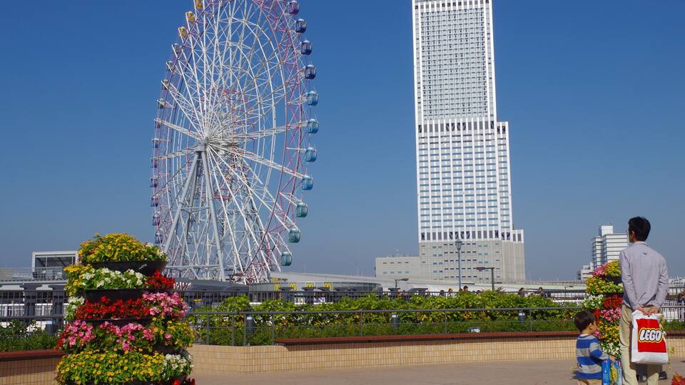 A Ferris wheel and a tall skyscraper.