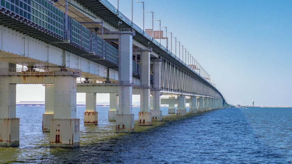 A large bridge spanning a body of water with multiple support pillars.
