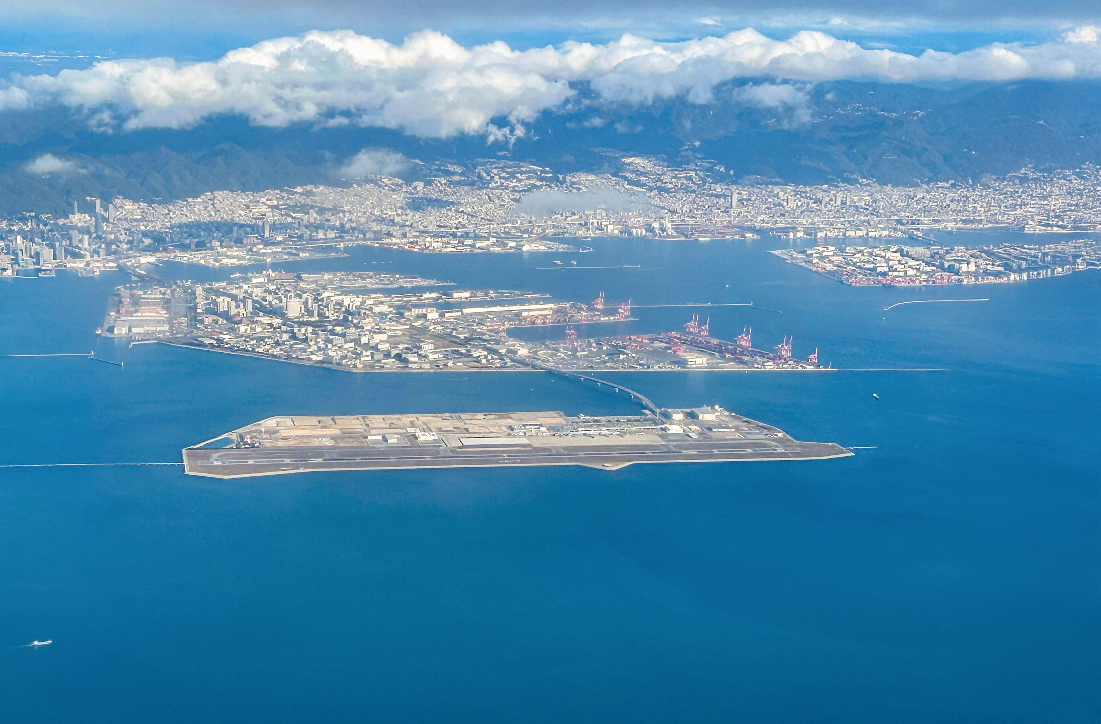 Aerial view of the Kansai International Airport (KIX) with izumisano city in background.