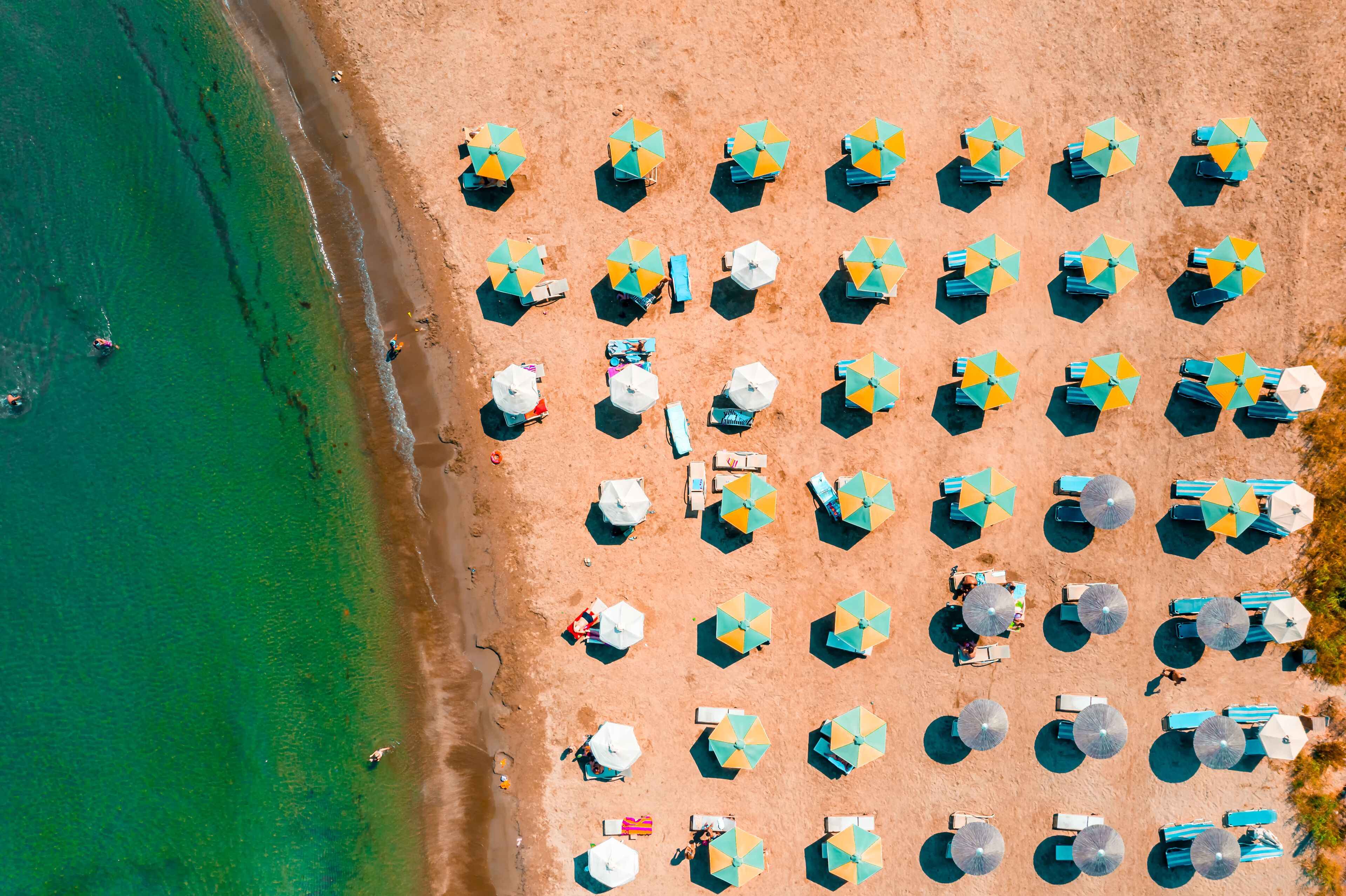 View of umbrellas and people relaxing and bathing at Alaminos beach. Larnaca District, Cyprus