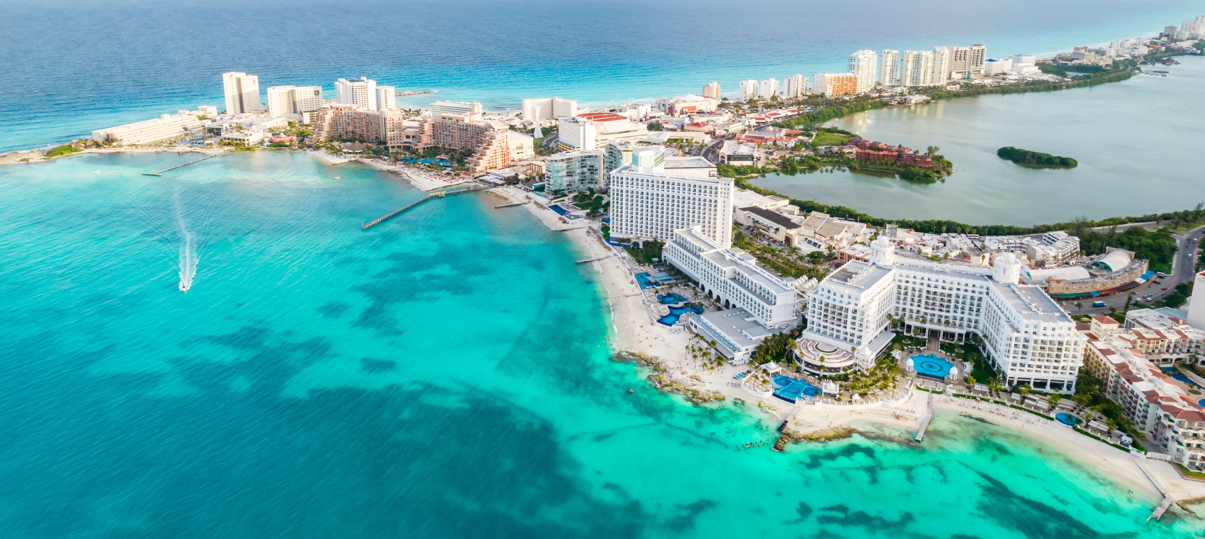 Aerial panoramic view of Cancun beach and city hotel zone in Mexico. Caribbean coast landscape of Mexican resort with beach Playa Caracol and Kukulcan road. Riviera Maya in Quintana roo region on