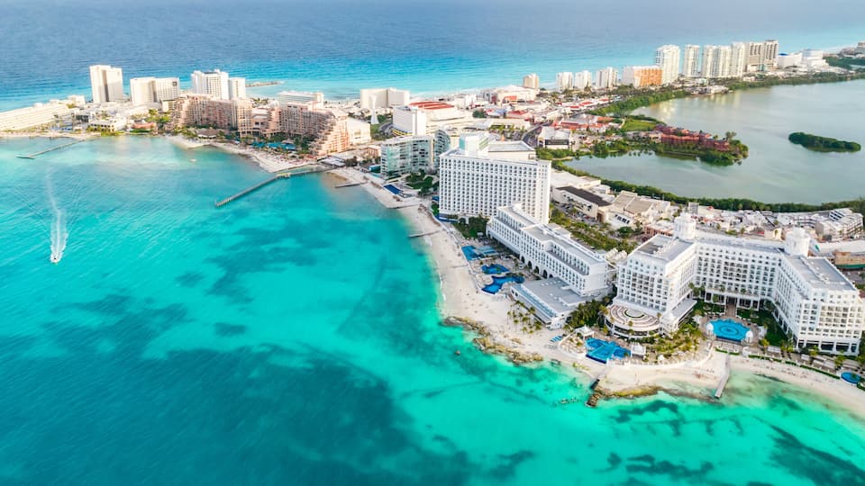 Aerial panoramic view of Cancun beach and city hotel zone in Mexico. Caribbean coast landscape of Mexican resort with beach Playa Caracol and Kukulcan road. Riviera Maya in Quintana roo region on