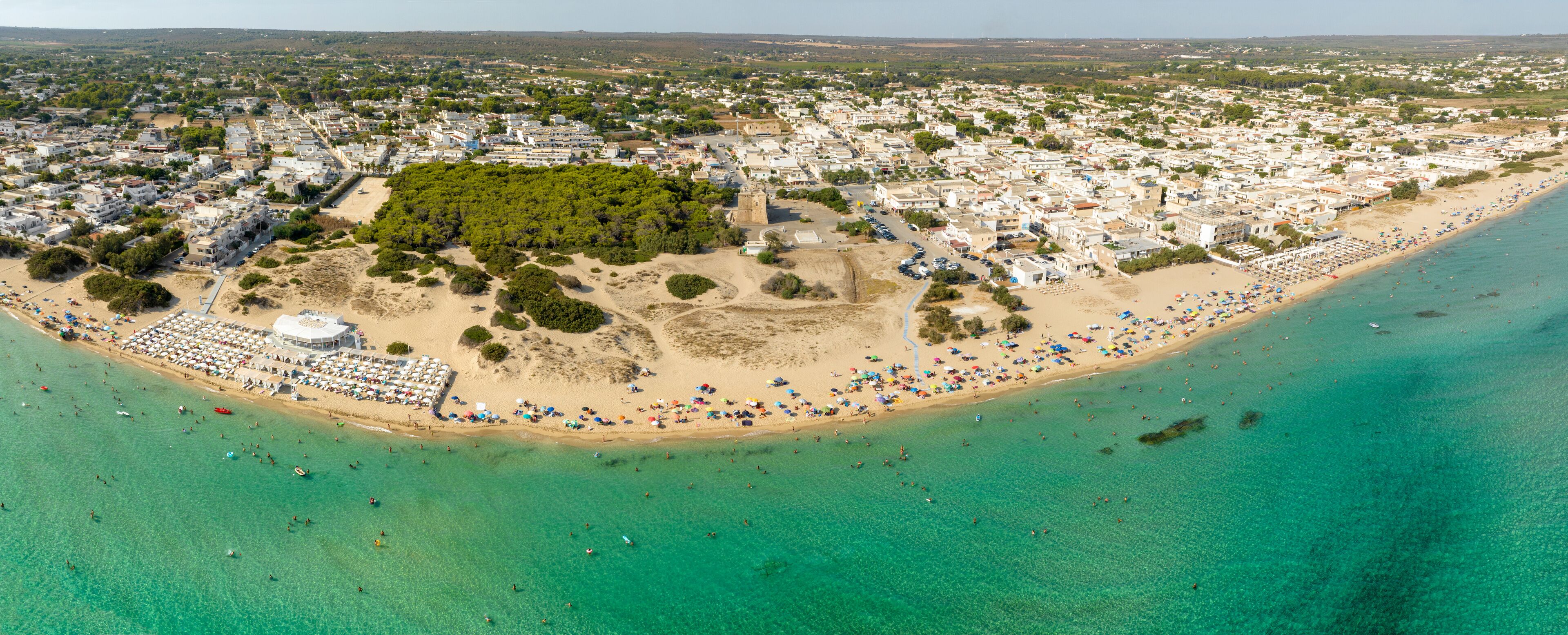 Aerial panoramic view of San Pietro in Bevagna in Salento. It is a small seaside town in the province of Taranto, Puglia, Italy. The water has Caribbean colors.