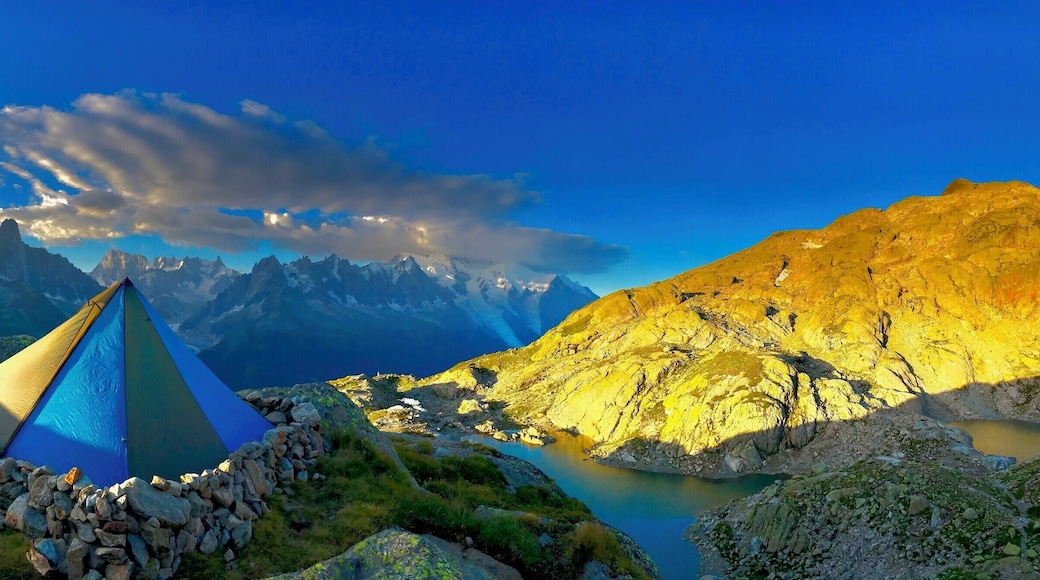 Sunrise in the east, the sunlight coming from the Swiss border into France on the Tour du Mont Blanc just above the Lac Blanc after a windy nights bivvy.