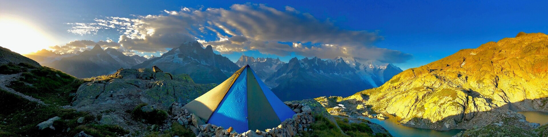 Sunrise in the east, the sunlight coming from the Swiss border into France on the Tour du Mont Blanc just above the Lac Blanc after a windy nights bivvy.