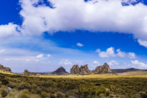 A landscape with rocky formations and a clear blue sky.