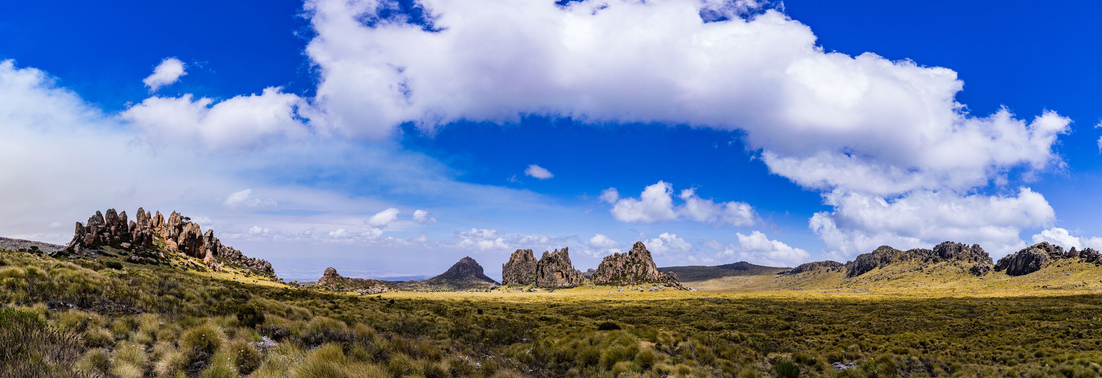 A landscape with rocky formations and a clear blue sky.