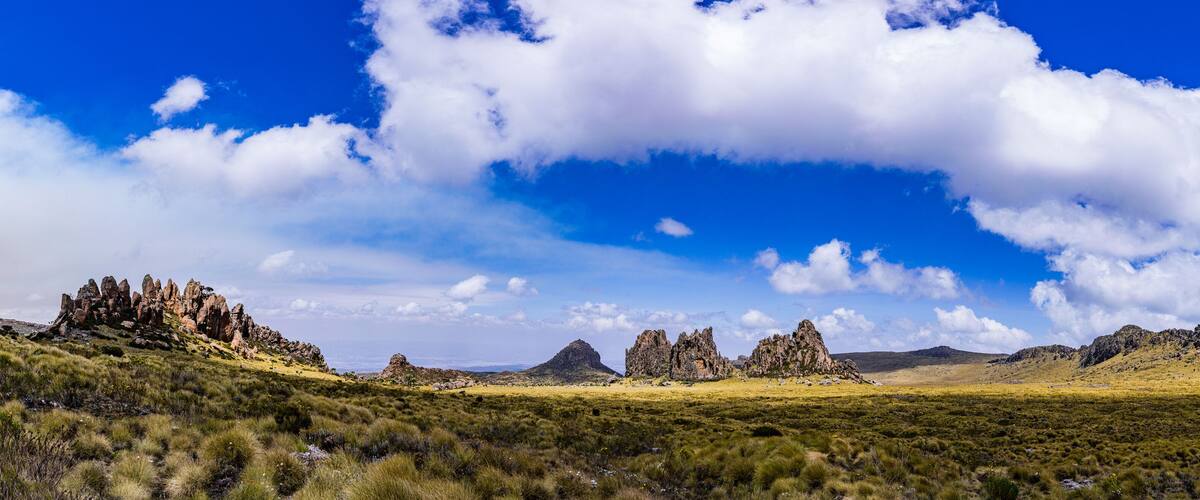 A landscape with rocky formations and a clear blue sky.