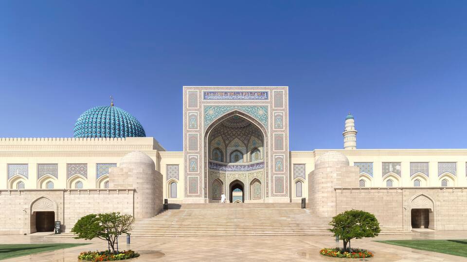 A large, ornate building with a prominent dome and intricate tile work.