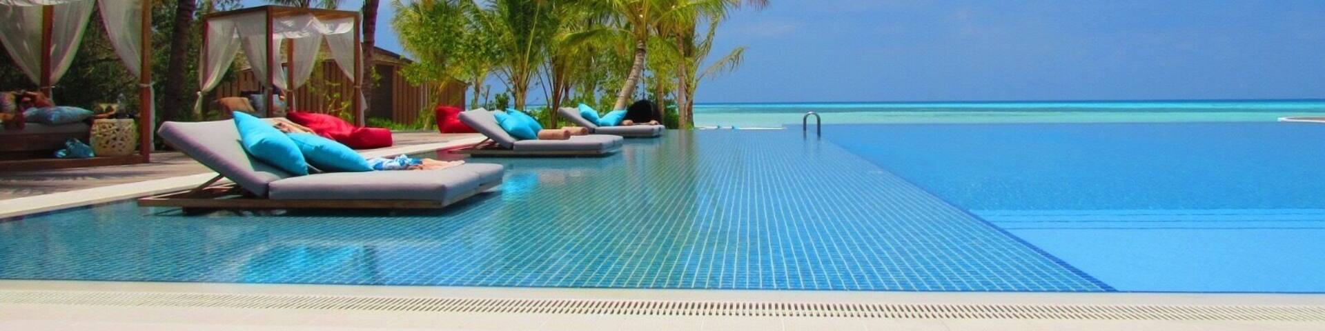 Hard to tell where the pool ends and the Indian Ocean begins. The blues and colours are stunning. Taken at the main pool at Club Med Finholu Villas in The Maldives.