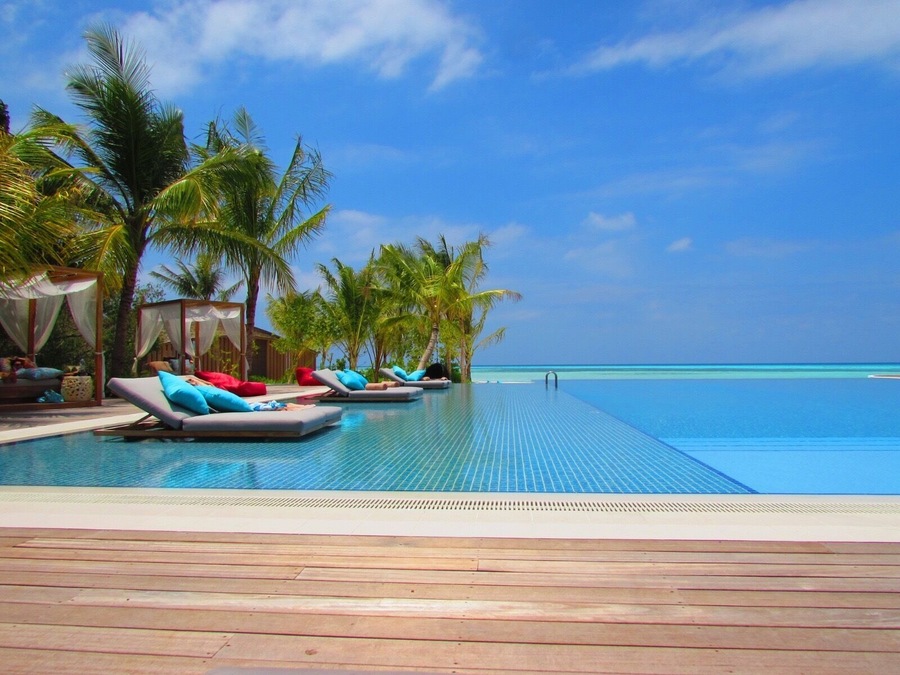 Hard to tell where the pool ends and the Indian Ocean begins. The blues and colours are stunning. Taken at the main pool at Club Med Finholu Villas in The Maldives.