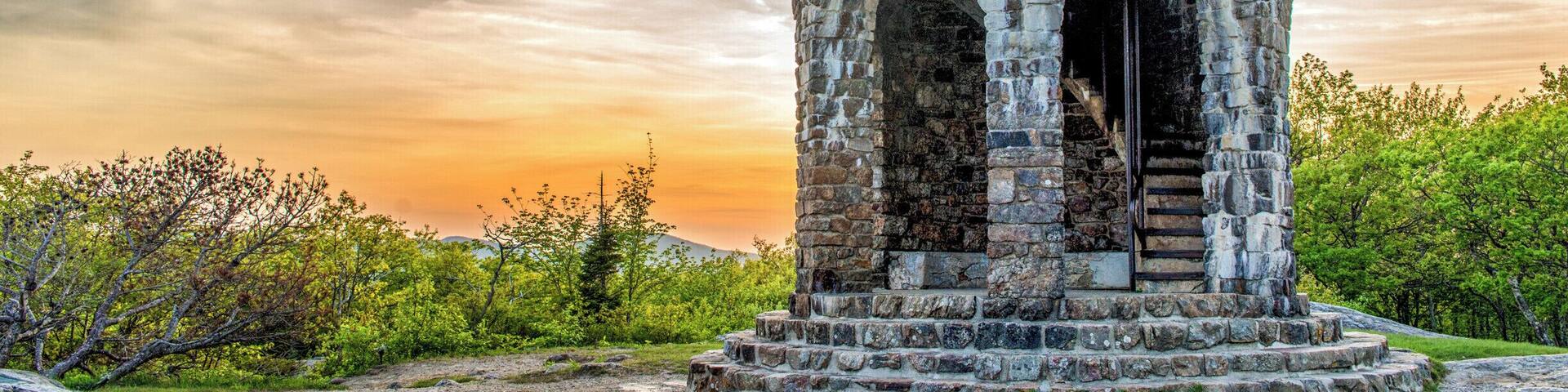 At the top of Mt Battie in Camden, Maine is this tower, constructed in 1921 as a WWI Memorial. There used to be a hotel on this site, but it was torn down in 1920. The tower was built on the site on the former hotel, and several stones from the hotel were used in the construction of the tower. There's a rather strenuous hike to the top of the mountain, but you can also drive right to the top within Camden Hills State Park. #mabattie #camden #camdenhills #maine #sunset #tower #goldenhour