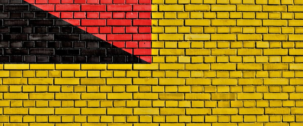 A yellow brick wall with a red and black diagonal stripe.