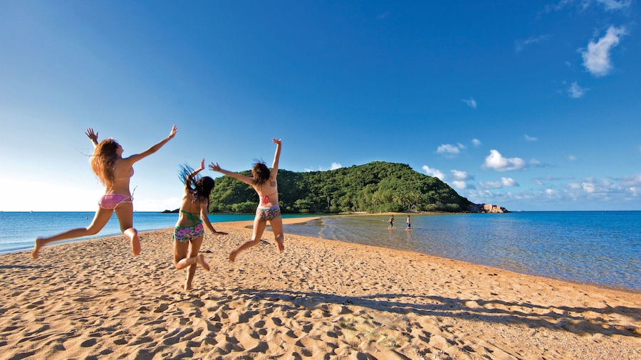 Ko Pha-ngan showing a sandy beach and general coastal views as well as a small group of people
