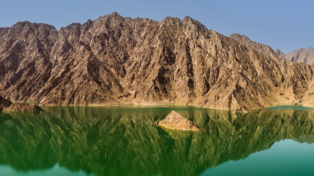 Reflection of rocks in the Hatta dam lake in the Dubai
