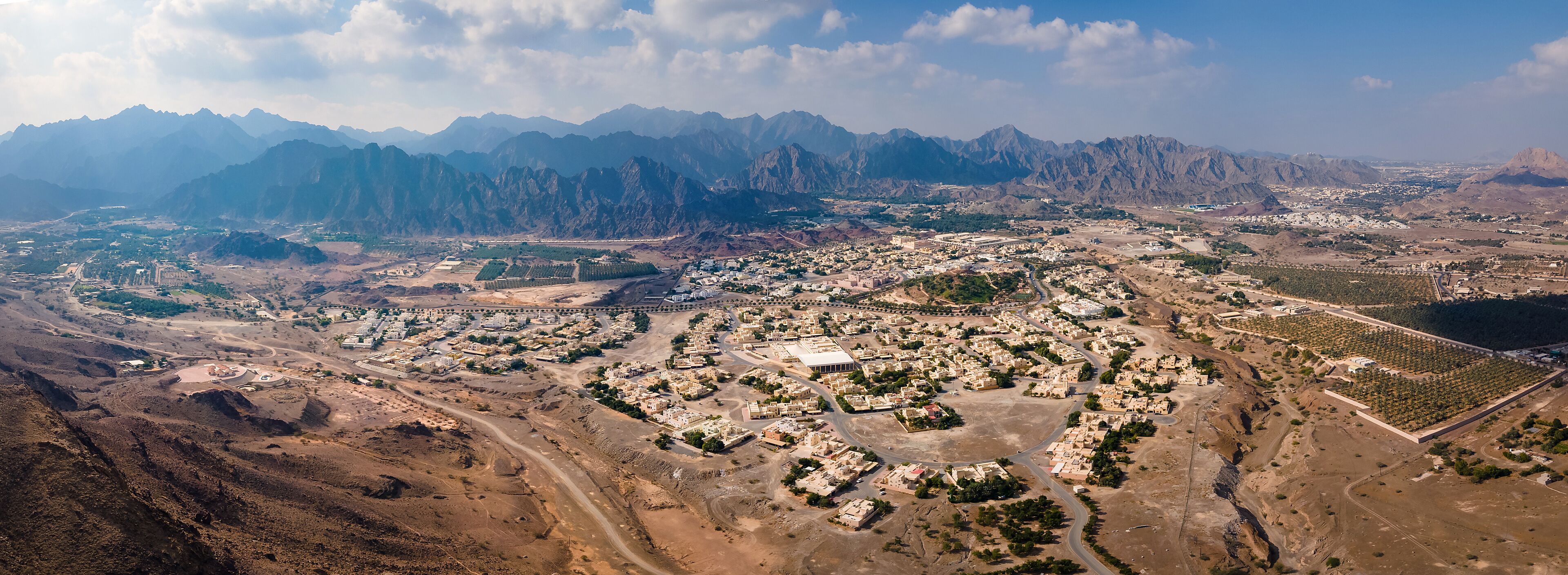 A mountainous landscape with a town nestled in the valley.