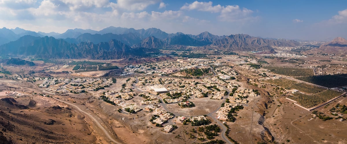 A mountainous landscape with a town nestled in the valley.