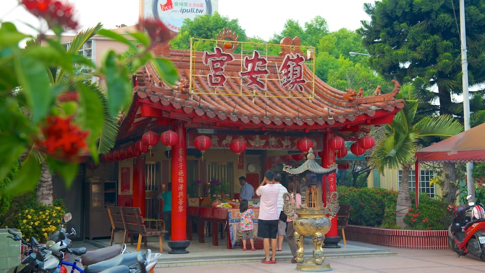 A traditional Chinese temple with red lanterns and a golden incense burner.