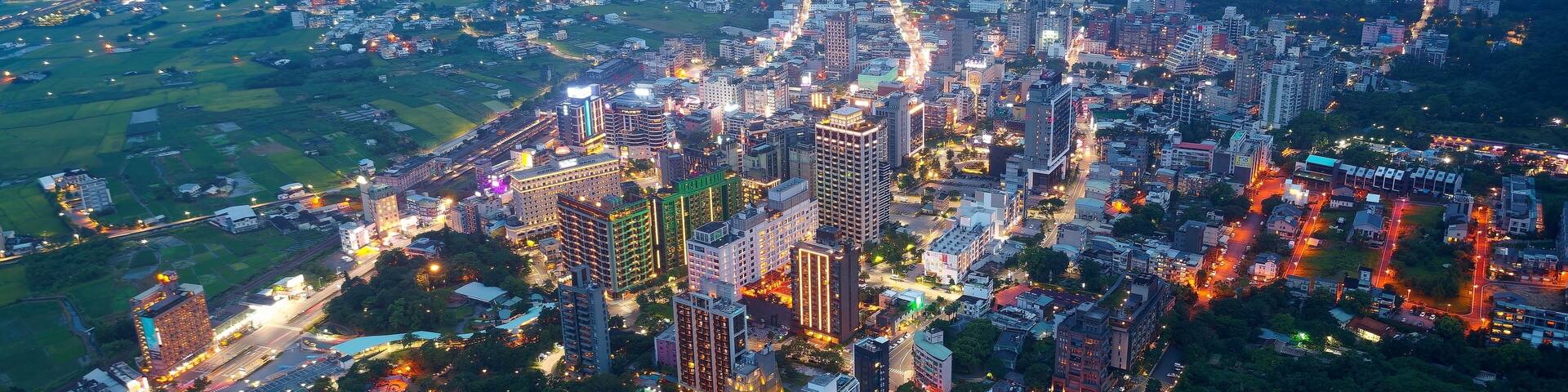 Aerial view of the high-rise buildings and hotels at blue dusk in Downtown Jiaoxi, which is a famous hot spring resort and tourist destination in Yilan County, Taiwan, on a cloudy moody evening