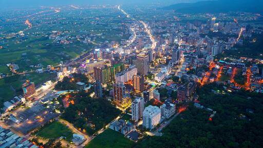 Aerial view of the high-rise buildings and hotels at blue dusk in Downtown Jiaoxi, which is a famous hot spring resort and tourist destination in Yilan County, Taiwan, on a cloudy moody evening