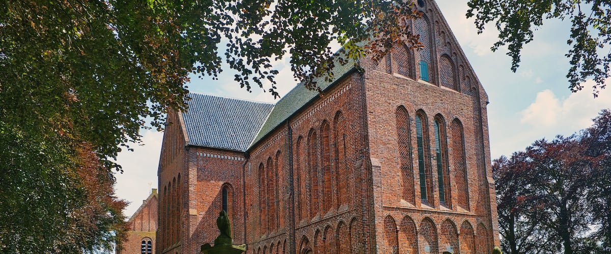 The impressive nave of the cruciform Romano-Gothic St. Peter’s church (Petruskerk, 15th century), surrounded by an old cemetery, in Zuidbroek, province of Groningen, the Netherlands