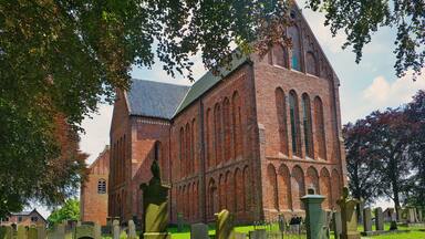 The impressive nave of the cruciform Romano-Gothic St. Peter’s church (Petruskerk, 15th century), surrounded by an old cemetery, in Zuidbroek, province of Groningen, the Netherlands