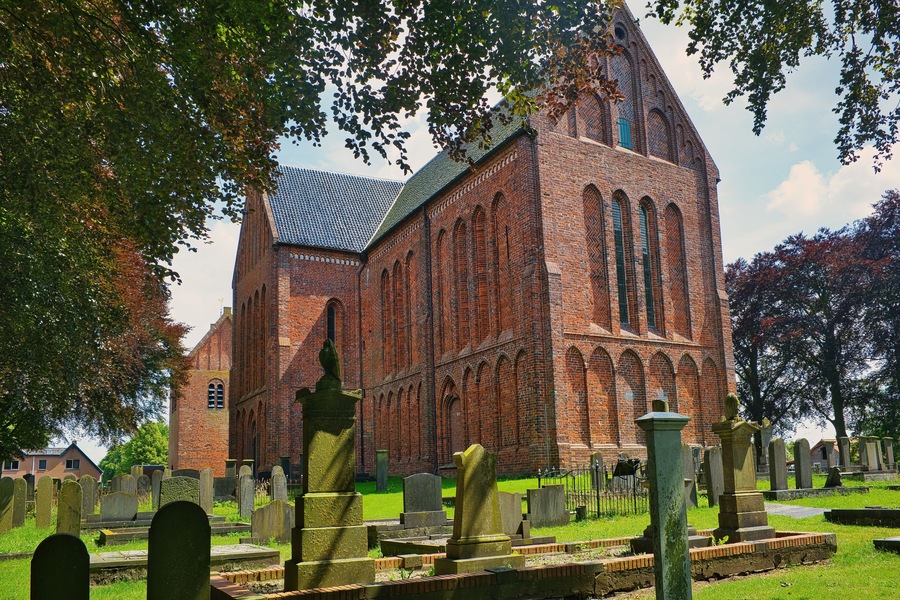 The impressive nave of the cruciform Romano-Gothic St. Peter’s church (Petruskerk, 15th century), surrounded by an old cemetery, in Zuidbroek, province of Groningen, the Netherlands