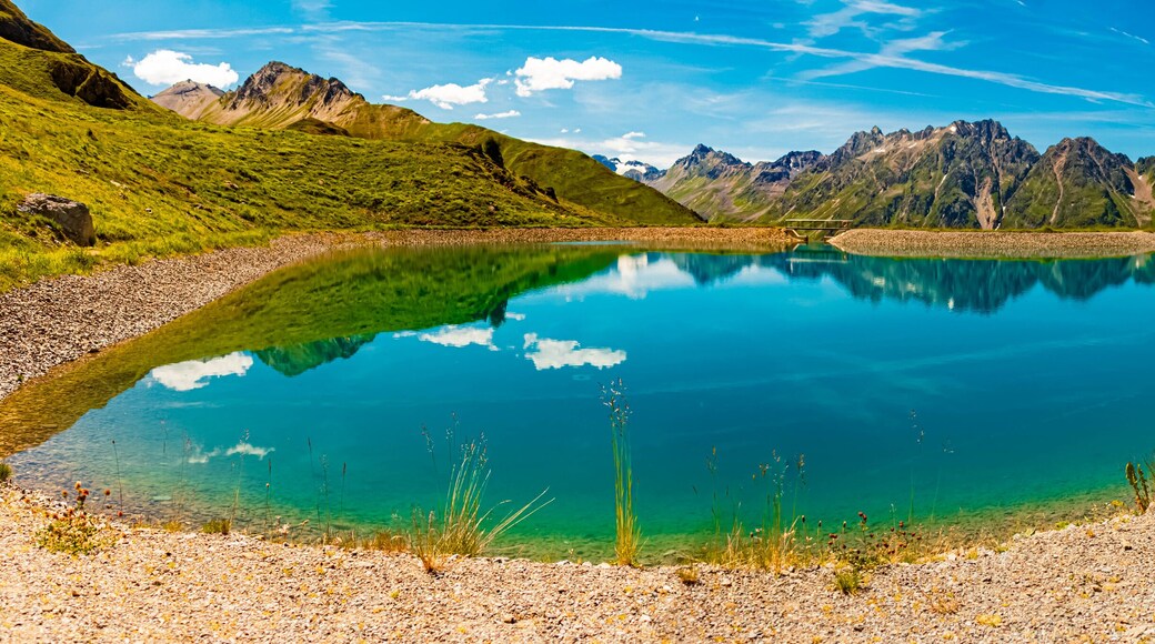 High resolution stitched alpine summer panorama with reflections in a lake at Mount Flimjoch, Ischgl, Paznaun, Silvretta, Landeck, Tyrol, Austria