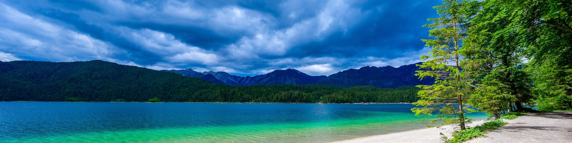 Paradise beach at Eibsee lake. Beautiful landscape scenery with clear blue water in German Alps at Zugspitze mountain - Garmisch Partenkirchen, Grainau - Bavaria, Germany, Europe.