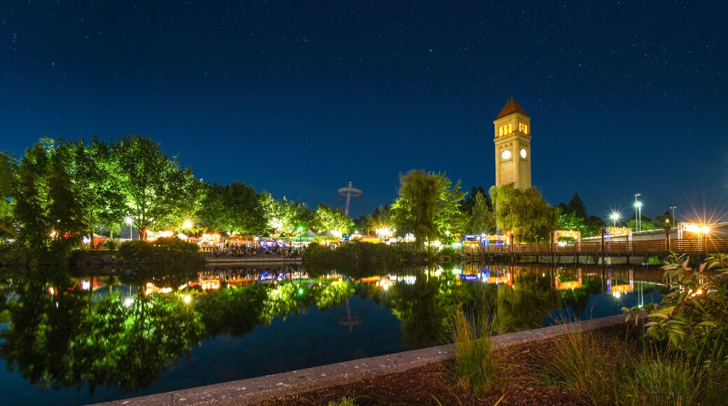 The Spokane Washington clocktower in Riverfront Park shines above the Spokane River during a busy festival in Riverfront Park, in Spokane Washington, USA