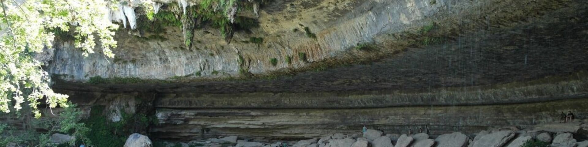 Hamilton Pool Preserve is a historic swimming hole located 3/4 mile upstream from its confluence with the Pedernales River, which is right outside of Austin. Hamilton Creek spills out over limestone outcroppings to create a 50 foot waterfall as it plunges into the head of a steep box canyon. The waterfall never completely dries up, but in dry times it does slow to a trickle. However, the pool's water level stays pretty constant, even during periods of drought. No pets of any kind are allowed. Only a limited number of people are allowed to enter so arrive early, people wait outside and as people leave, others are allowed in. There are no lifeguards on duty so swim at your own risk. There are areas that get pretty deep.