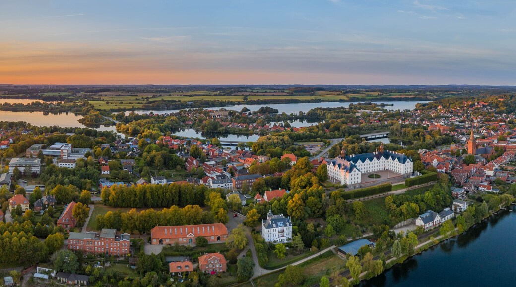 Panorama aerial view of castle Plon (Plöner Schloss) on the shore of lake Plon (Plöner See) and its surrounding landscape Schleswig-Holstein, Germany