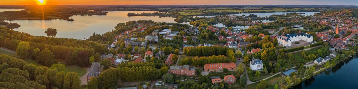 Panorama aerial view of castle Plon (Plöner Schloss) on the shore of lake Plon (Plöner See) and its surrounding landscape Schleswig-Holstein, Germany