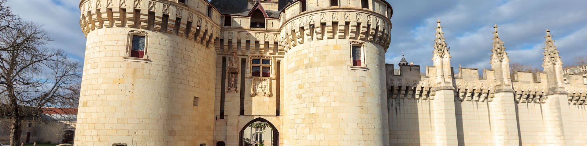 Dissay castle, near Poitiers, in France, full view under the sun, sometimes referred as Sleeping Beauty castle, with moat and bridge, now rehabilitated in a luxury hotel