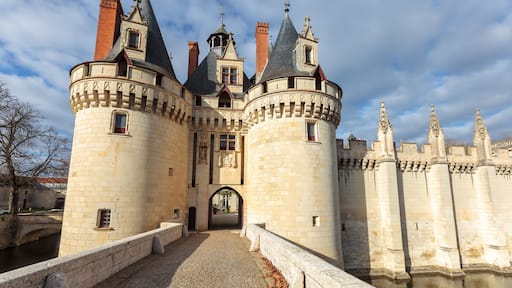 Dissay castle, near Poitiers, in France, full view under the sun, sometimes referred as Sleeping Beauty castle, with moat and bridge, now rehabilitated in a luxury hotel