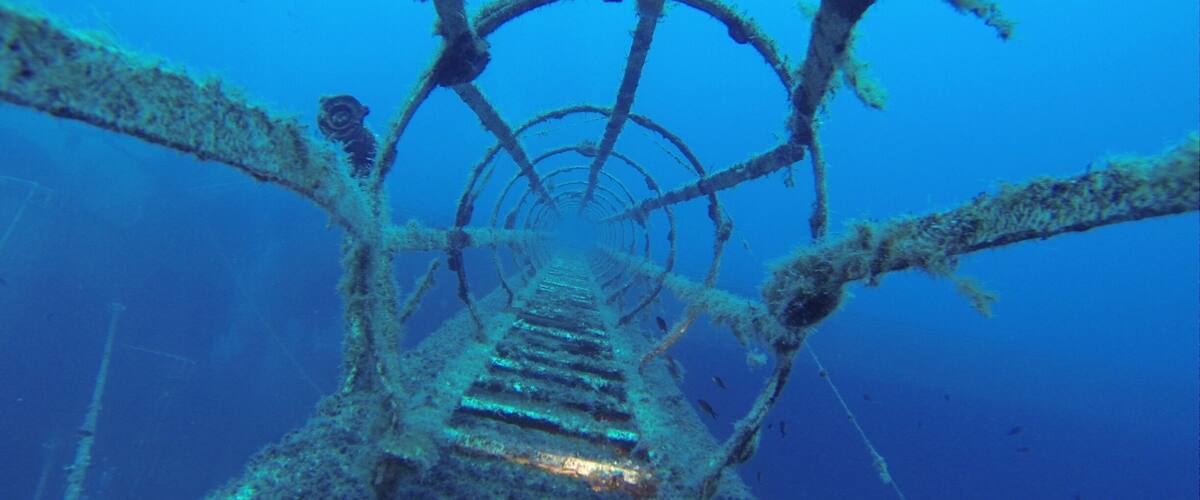 An underwater structure with a central shaft and branching supports.
