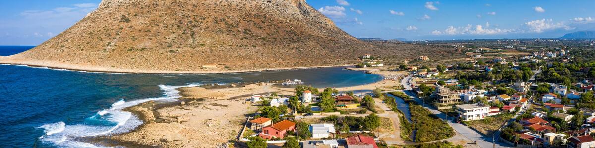 Aerial drone top view of turquoise organised beach forming a small heart shaped lagoon and mountainous seascape of Stavros, Chania, Crete island, Greece. Picturesque Stavros beach at Crete, Greece.