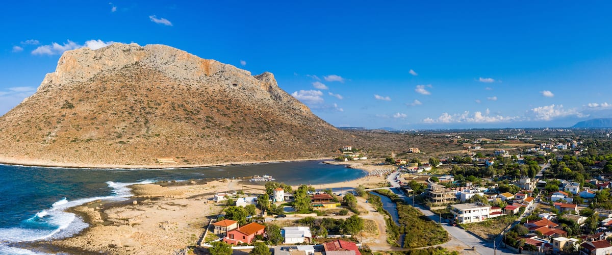 Aerial drone top view of turquoise organised beach forming a small heart shaped lagoon and mountainous seascape of Stavros, Chania, Crete island, Greece. Picturesque Stavros beach at Crete, Greece.