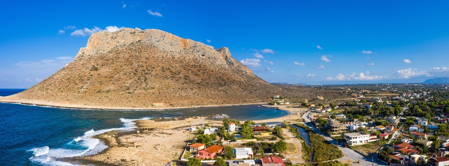 Aerial drone top view of turquoise organised beach forming a small heart shaped lagoon and mountainous seascape of Stavros, Chania, Crete island, Greece. Picturesque Stavros beach at Crete, Greece.
