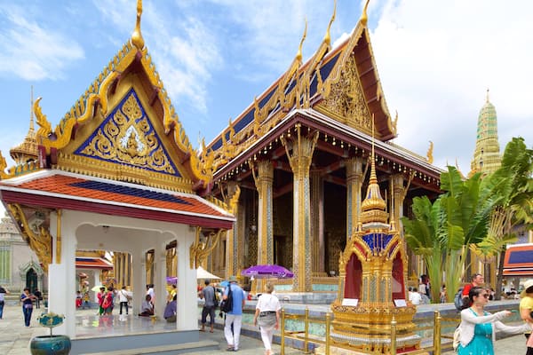 Temple of the Emerald Buddha which includes a temple or place of worship as well as a large group of people