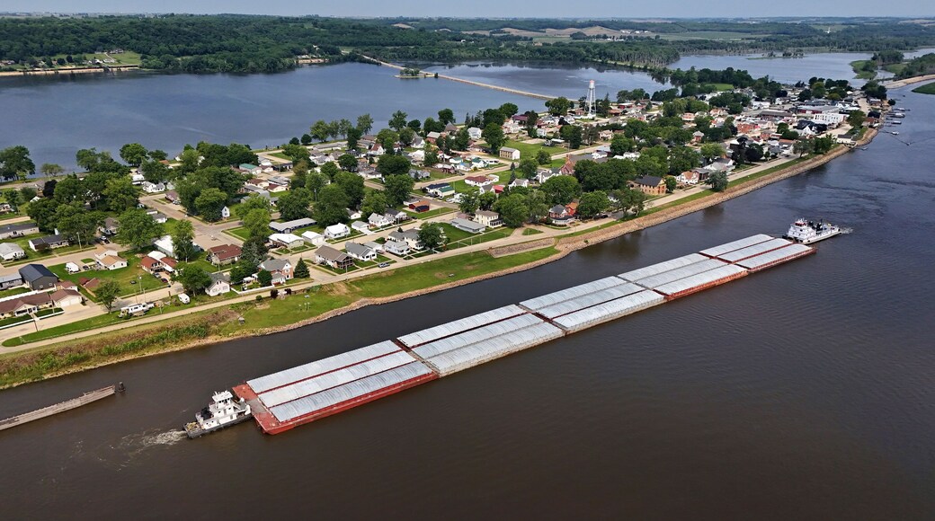Aerial view of Sabula, Iowa with tub boats and barges on the Mississippi River in the foreground