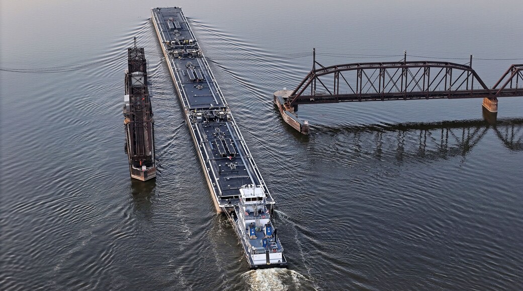 Set of liquid cargo barges being pushed through the narrow opening of the railroad swing bridge at Sabula Iowa