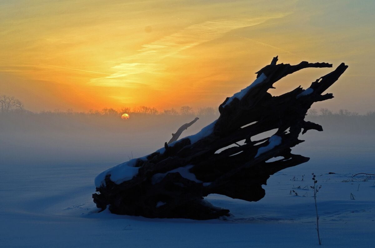 Sunrise over the Mississippi River. This was a cold morning during a nasty Winter when the river was frozen solid. the river has steady current so it has to be cold to freeze solid.