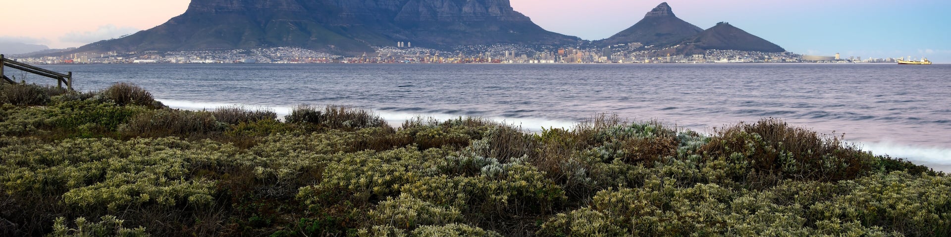 Table Mountain silhouetted against the morning sky as viewed from Sunset Beach in Milnerton, Cape Town South Africa.